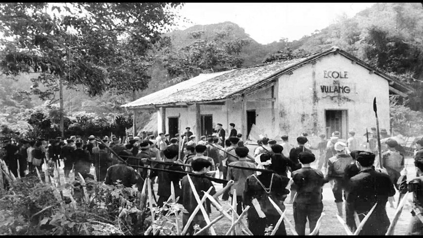 Villagers gathering outside the Vũ Lăng school during the Bắc Sơn Uprising, 1940
